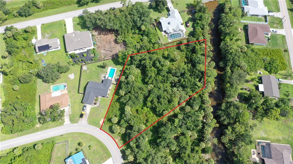 284 Hinton Street Port Charlotte, FL 33954 - Photo 3 of 16 an aerial view of house with swimming pool outdoor seating and yard