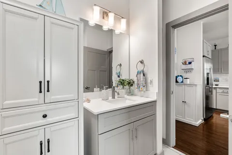 a bathroom with a sink vanity and a mirror