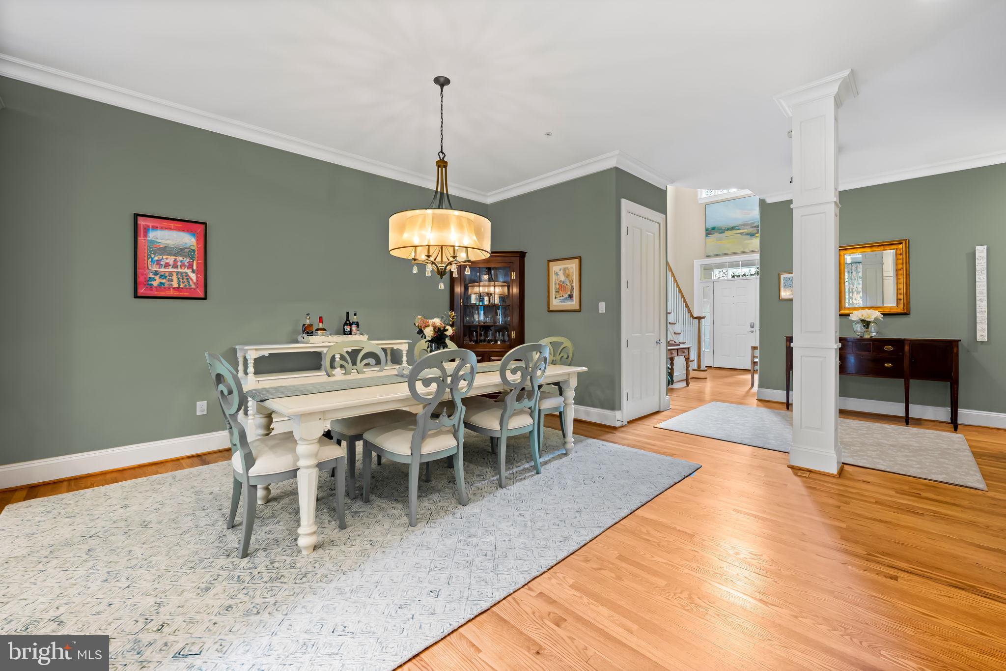 6509 Abbey View Way, Unit 22 Baltimore, MD 21212 - Photo 13 of 54 a view of a dining room and livingroom with furniture wooden floor a chandelier