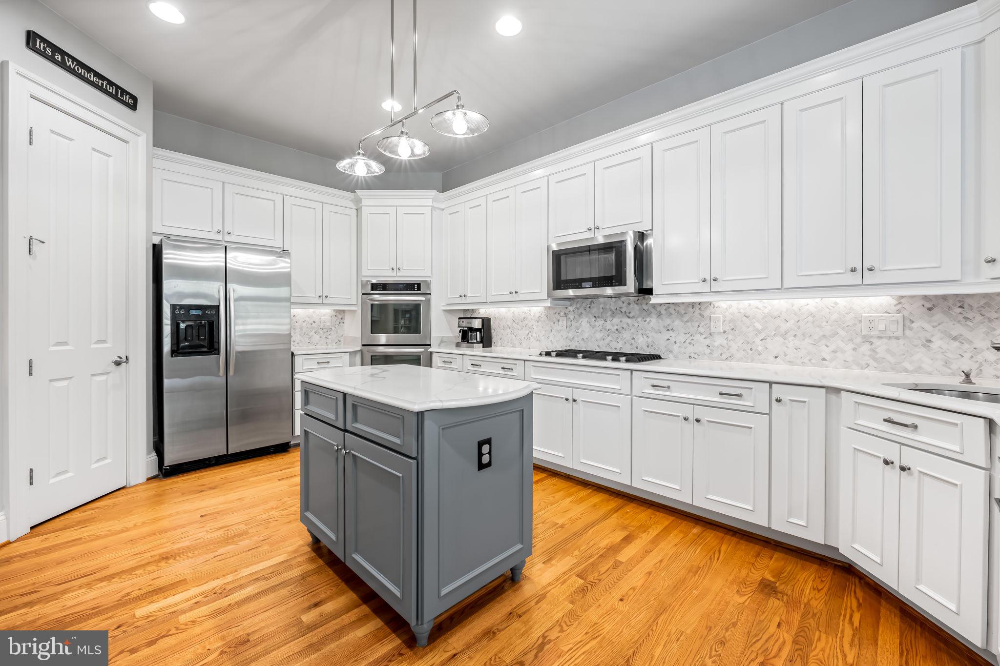 6509 Abbey View Way, Unit 22 Baltimore, MD 21212 - Photo 14 of 54 a kitchen with stainless steel appliances granite countertop a stove a sink dishwasher a refrigerator and a microwave oven with white cabinets