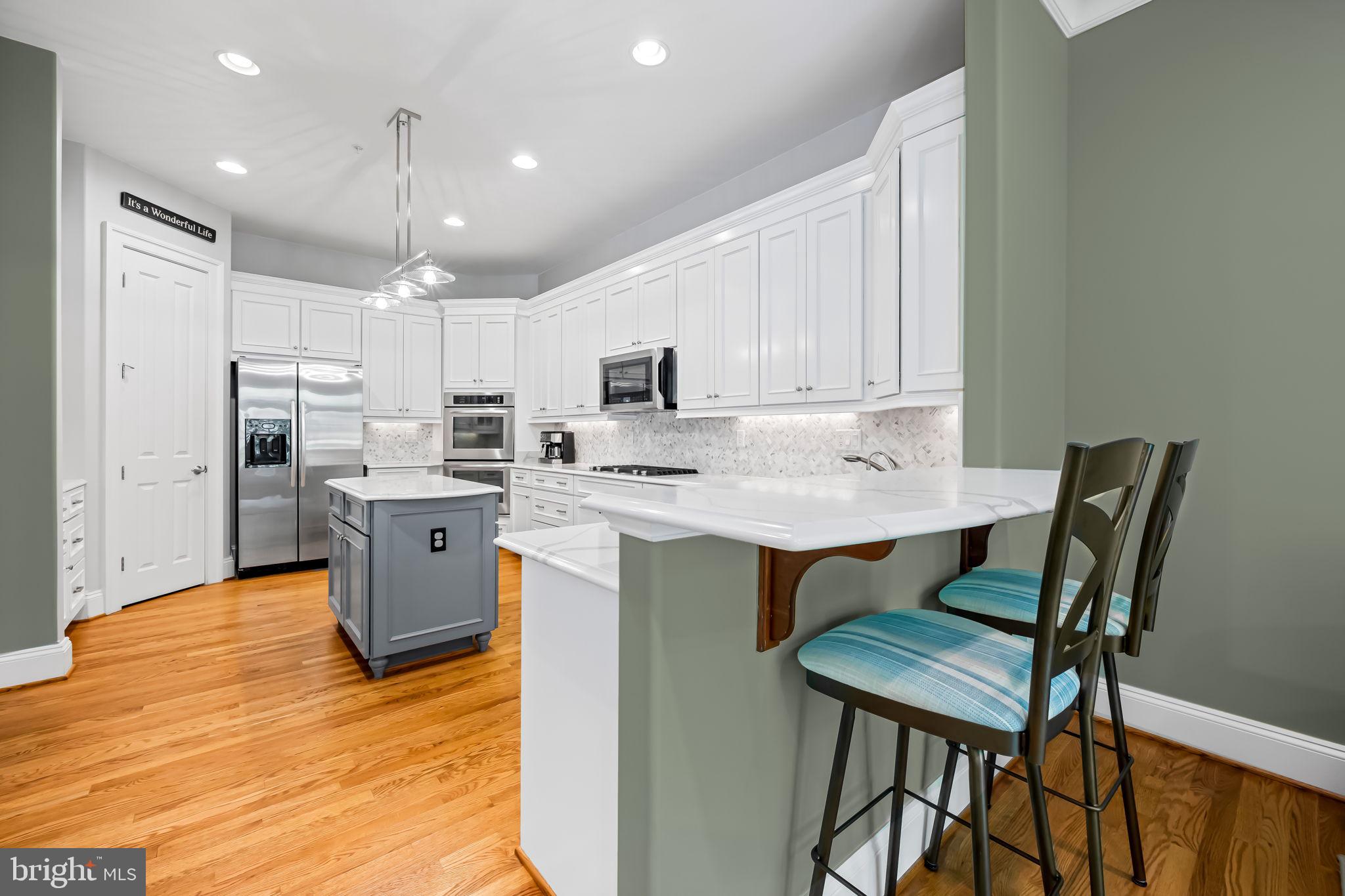 6509 Abbey View Way, Unit 22 Baltimore, MD 21212 - Photo 19 of 54 a kitchen with a dining table chairs and refrigerator