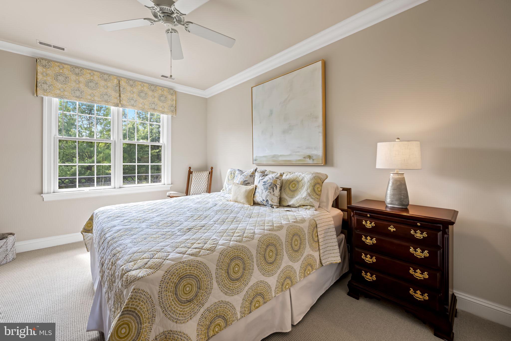 6509 Abbey View Way, Unit 22 Baltimore, MD 21212 - Photo 33 of 54 a bedroom with a bed and a lamp on dresser