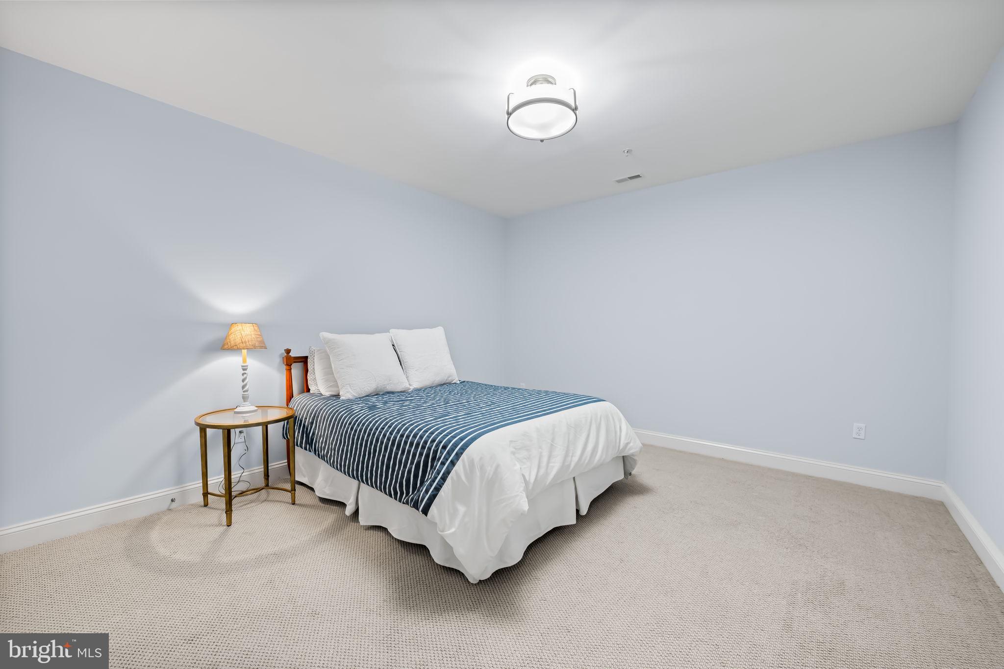 6509 Abbey View Way, Unit 22 Baltimore, MD 21212 - Photo 39 of 54 a bedroom with a bed and a lamp