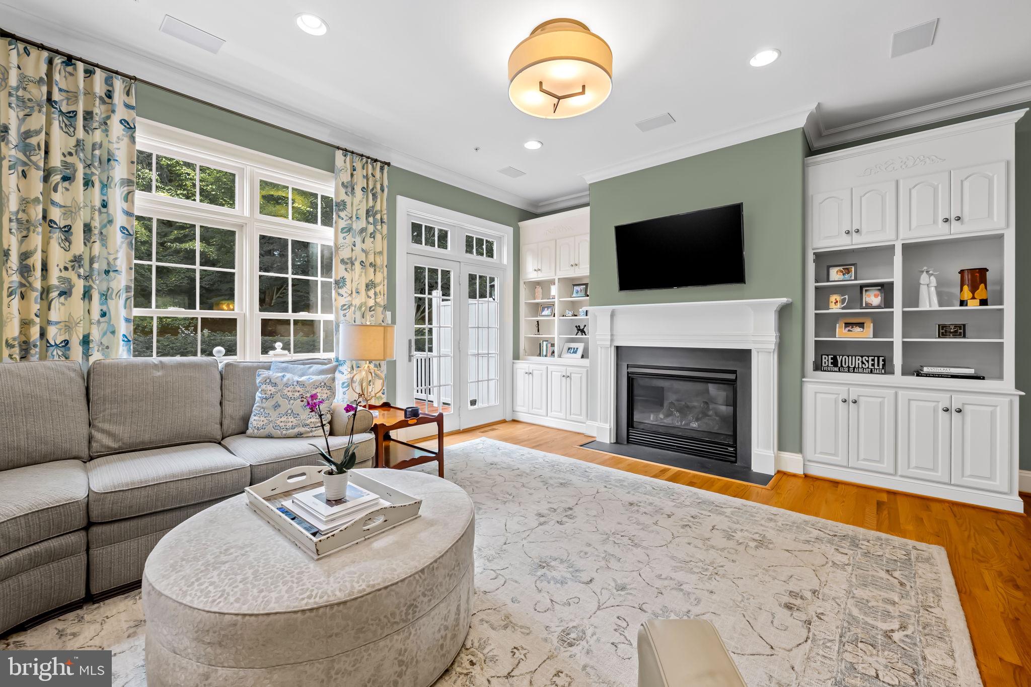 6509 Abbey View Way, Unit 22 Baltimore, MD 21212 - Photo 8 of 54 a living room with furniture a fireplace and a flat screen tv