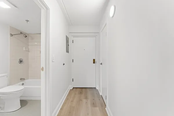 a view of a hallway with wooden floor