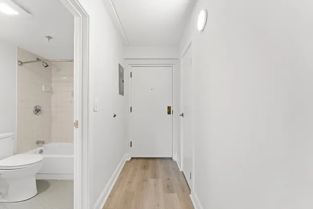 a view of a hallway with wooden floor