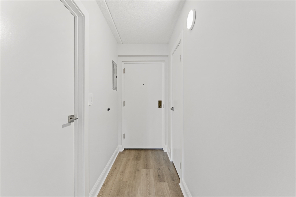 275 Main Street, Unit 205 Watertown, MA 02472 - Photo 19 of 42 a view of a hallway with wooden floor