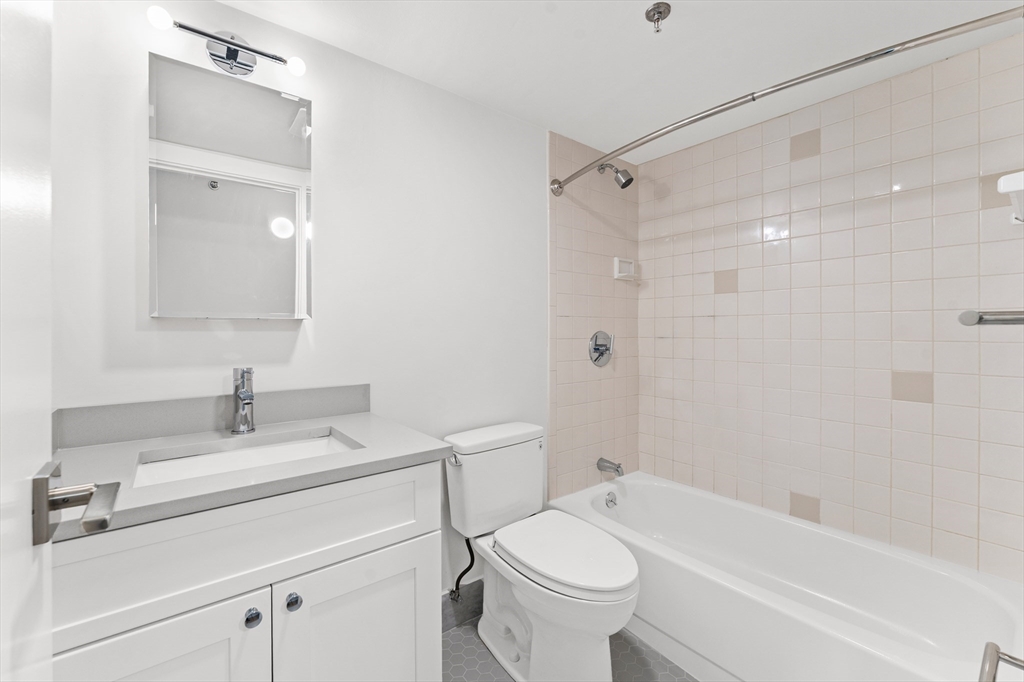 275 Main Street, Unit 205 Watertown, MA 02472 - Photo 20 of 42 a bathroom with a sink toilet and shower