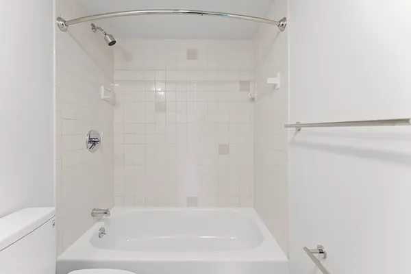 a bathroom with a shower and a bath tub