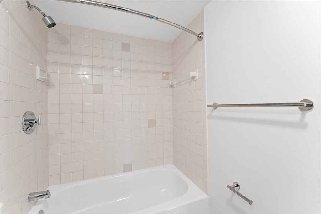 275 Main Street, Unit 205 Watertown, MA 02472 - Photo 24 of 42 a bathroom with a shower and a bath tub
