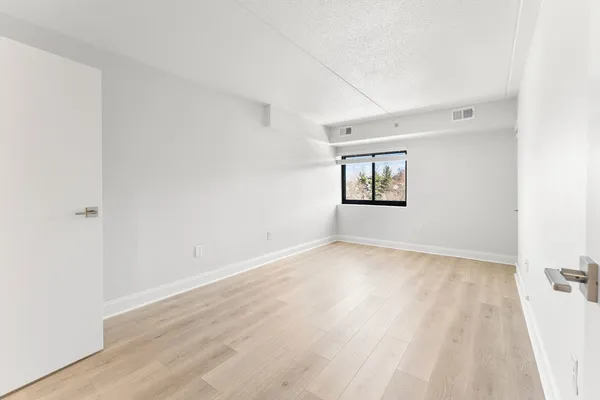 a view of an empty room and wooden floor