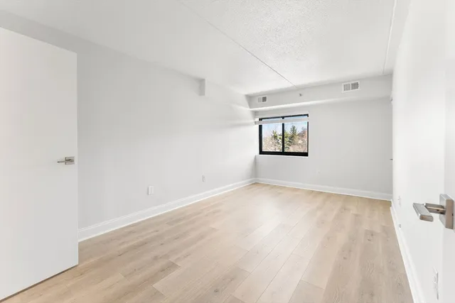 a view of an empty room and wooden floor
