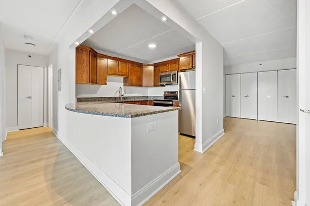 a kitchen with granite countertop a sink and cabinets