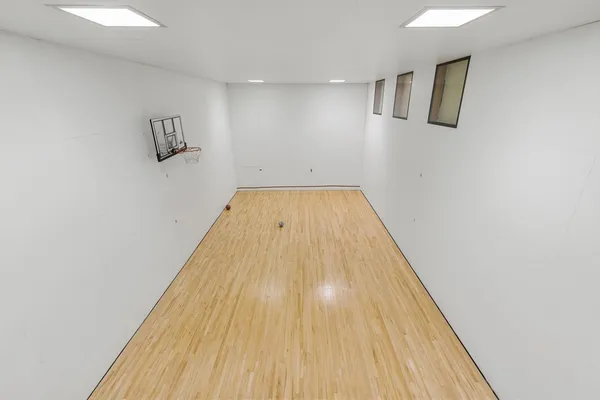 a room with furniture pool table and wooden floor