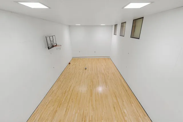 a room with furniture pool table and wooden floor