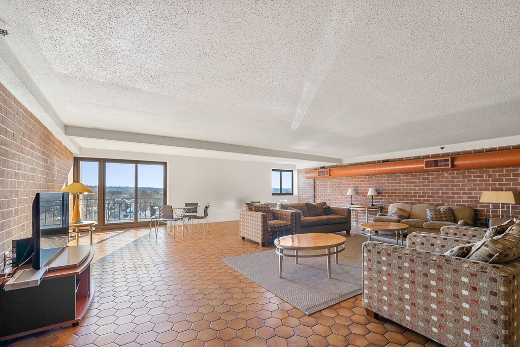 275 Main Street, Unit 205 Watertown, MA 02472 - Photo 42 of 42 a living room with furniture and a flat screen tv