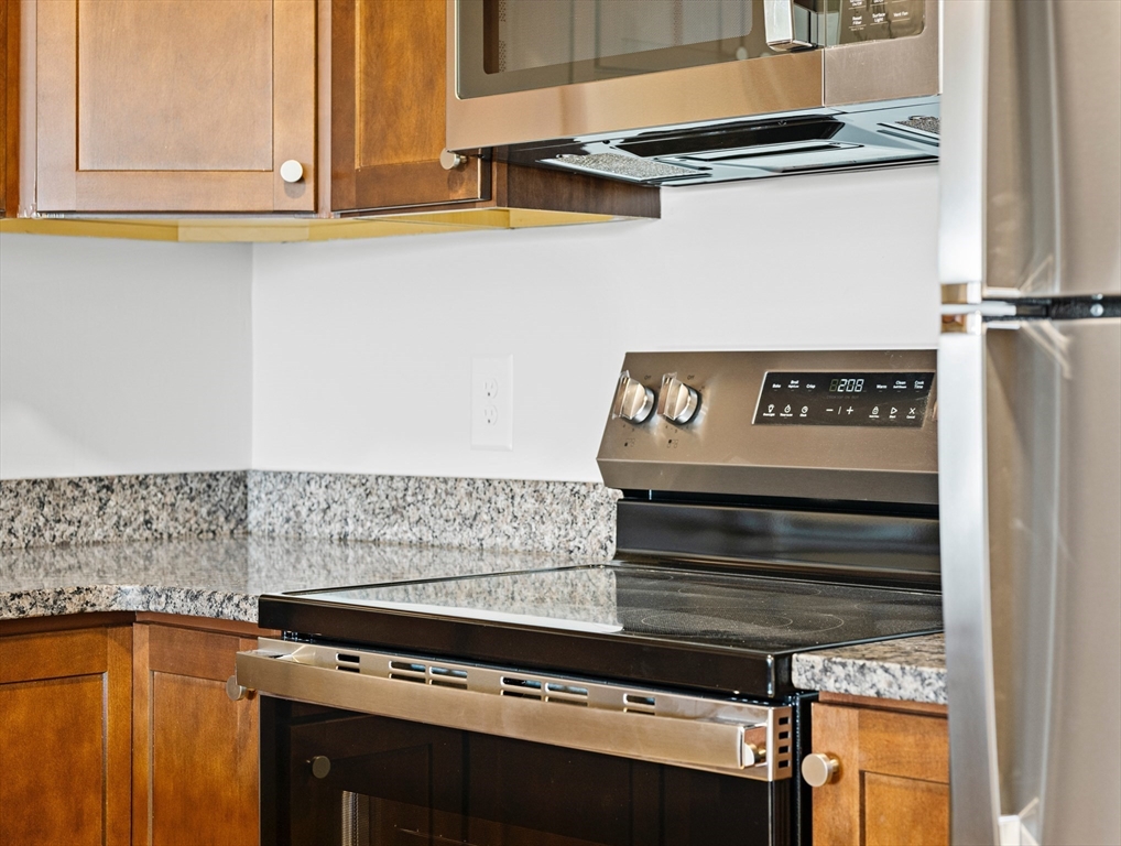 275 Main Street, Unit 205 Watertown, MA 02472 - Photo 9 of 42 a kitchen with a stove and a microwave