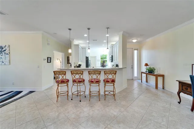 a kitchen with white cabinets granite counter tops and a sink