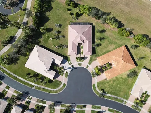 an aerial view of multiple houses with a yard