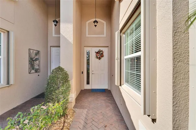a living room with furniture a chandelier and a dining table