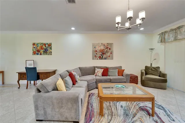 a dining hall with stainless steel appliances a dining table and chairs with kitchen view