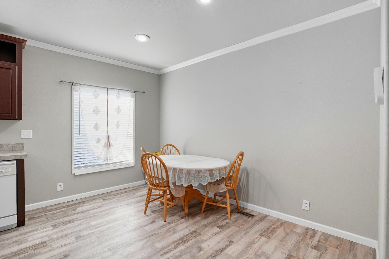 8665 Florin Road, Unit 133 Sacramento, CA 95828 - Photo 12 of 38 a view of a dining room with furniture and wooden floor
