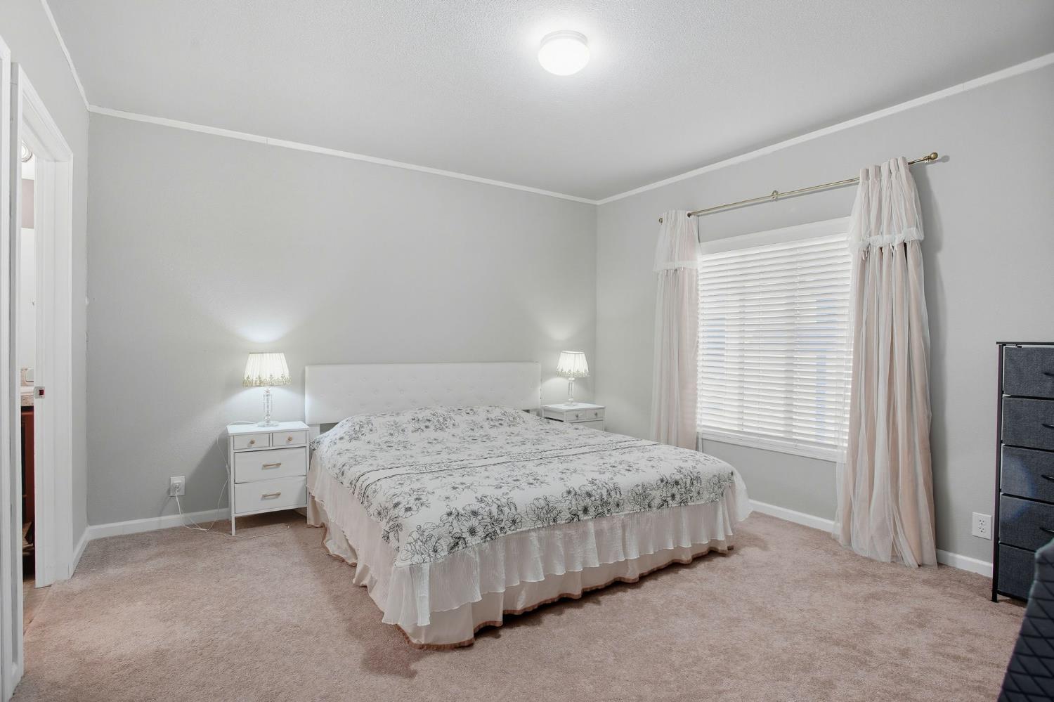 8665 Florin Road, Unit 133 Sacramento, CA 95828 - Photo 13 of 38 a bedroom with a bed and a window