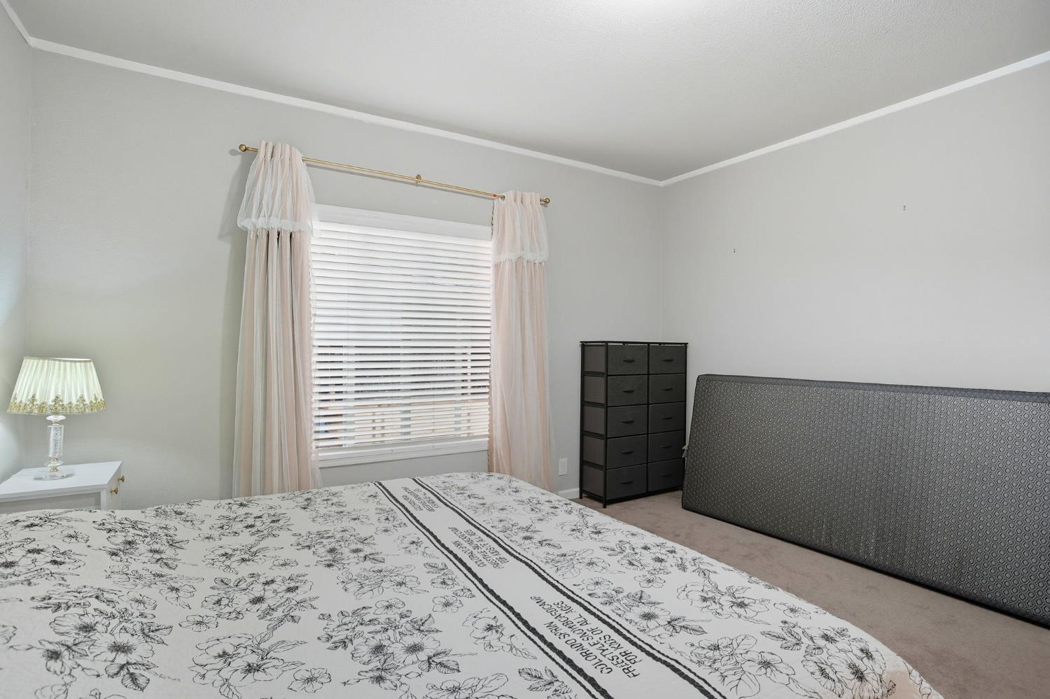 8665 Florin Road, Unit 133 Sacramento, CA 95828 - Photo 15 of 38 a bedroom with a bed and a window
