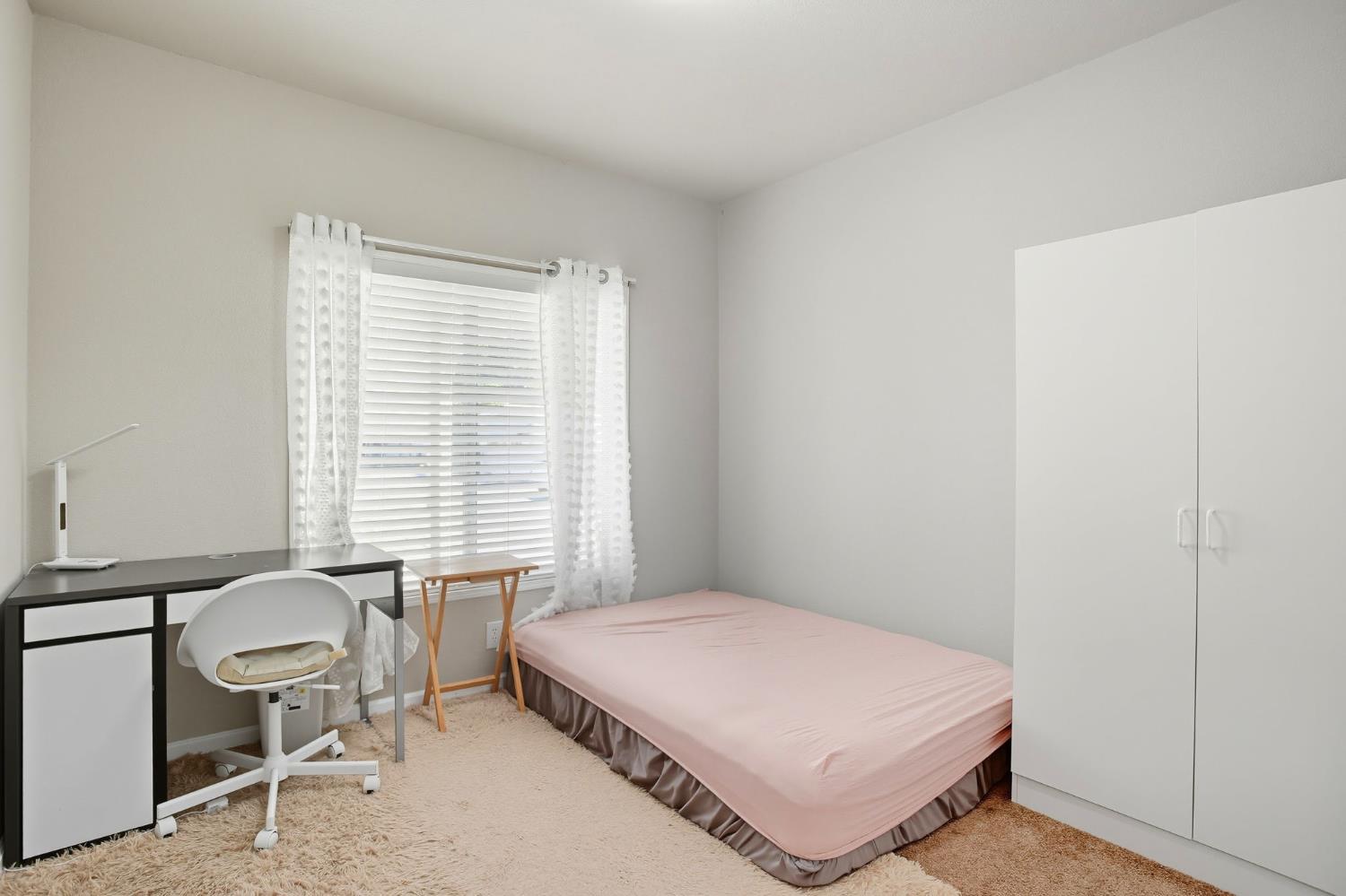 8665 Florin Road, Unit 133 Sacramento, CA 95828 - Photo 17 of 38 a bedroom with a bed a table and chair