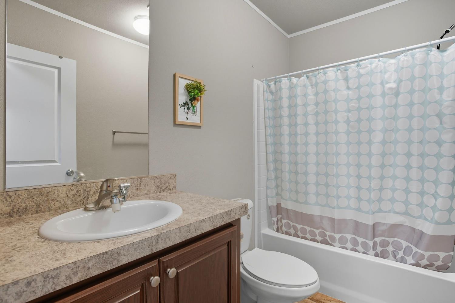 8665 Florin Road, Unit 133 Sacramento, CA 95828 - Photo 23 of 38 a bathroom with a granite countertop bathtub sink vanity mirror and toilet