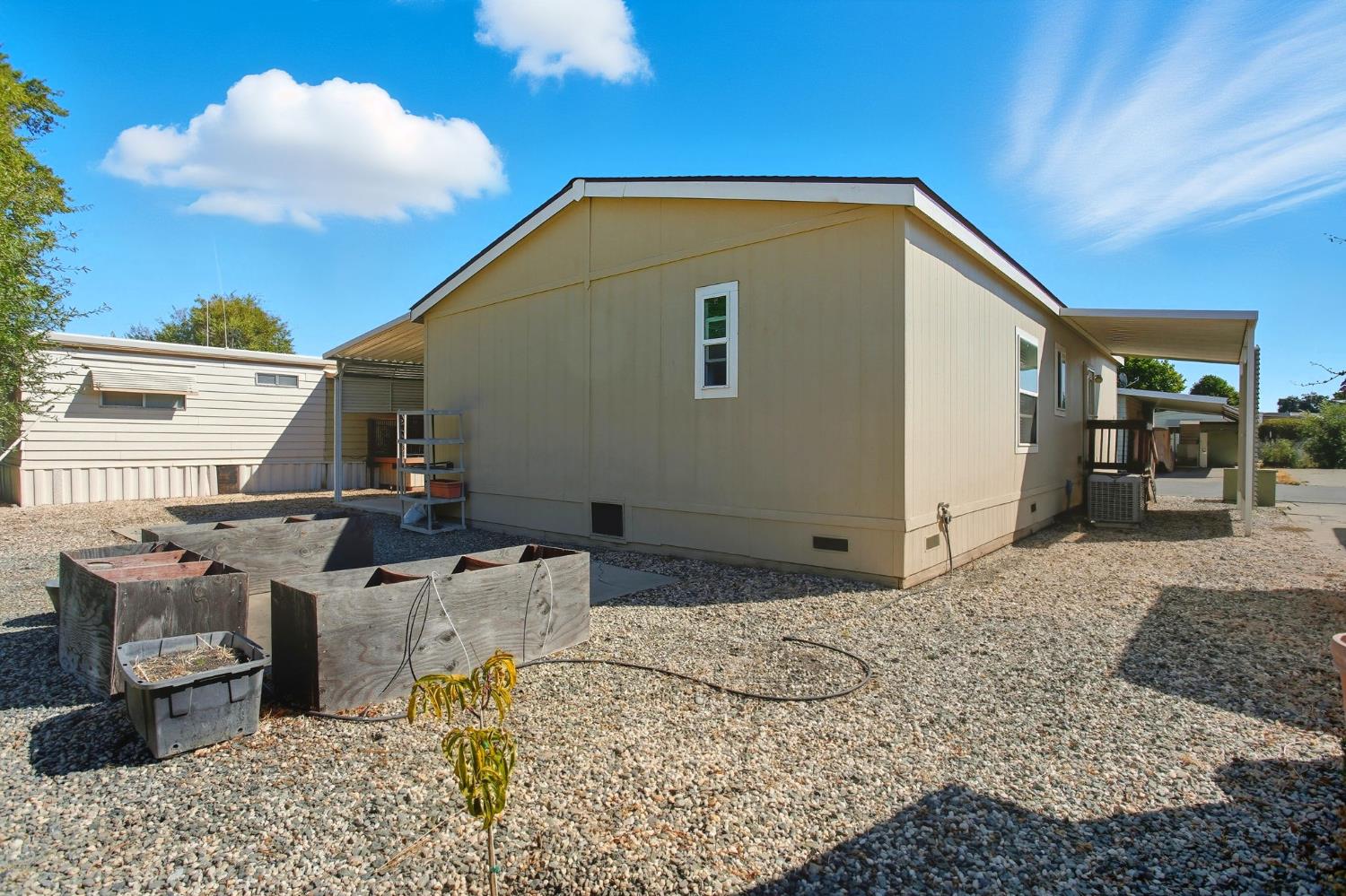 8665 Florin Road, Unit 133 Sacramento, CA 95828 - Photo 28 of 38 a backyard of a house with barbeque oven table and chairs