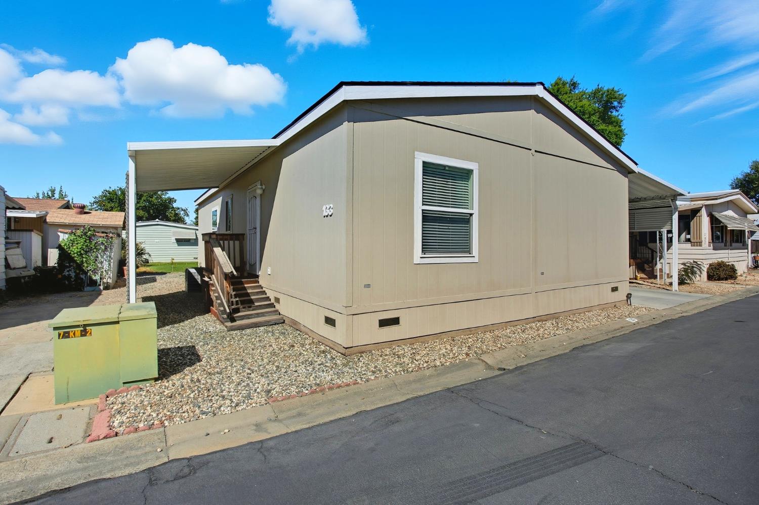 8665 Florin Road, Unit 133 Sacramento, CA 95828 - Photo 3 of 38 a front view of a house with garden