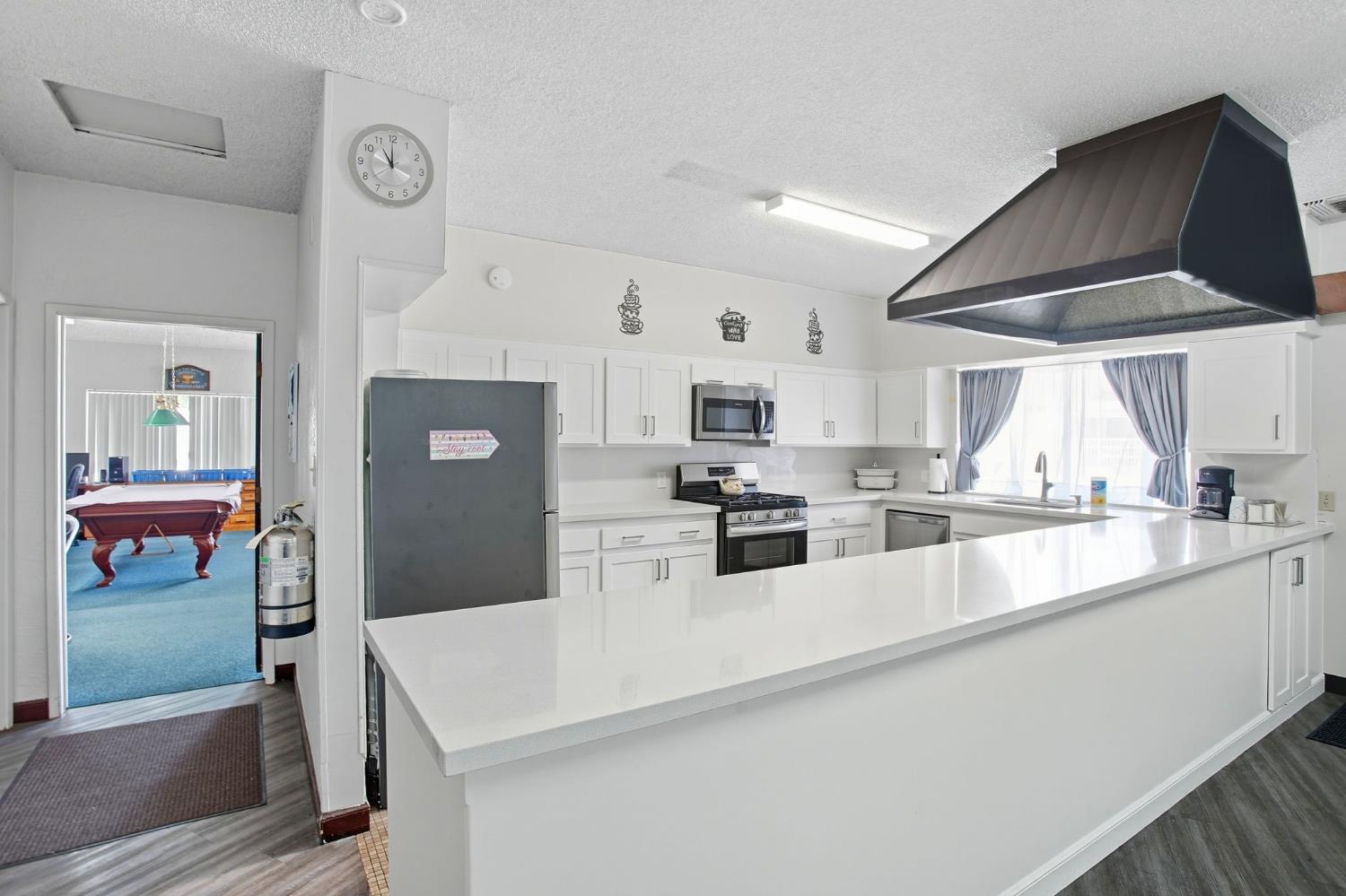 8665 Florin Road, Unit 133 Sacramento, CA 95828 - Photo 32 of 38 a large white kitchen with stainless steel appliances