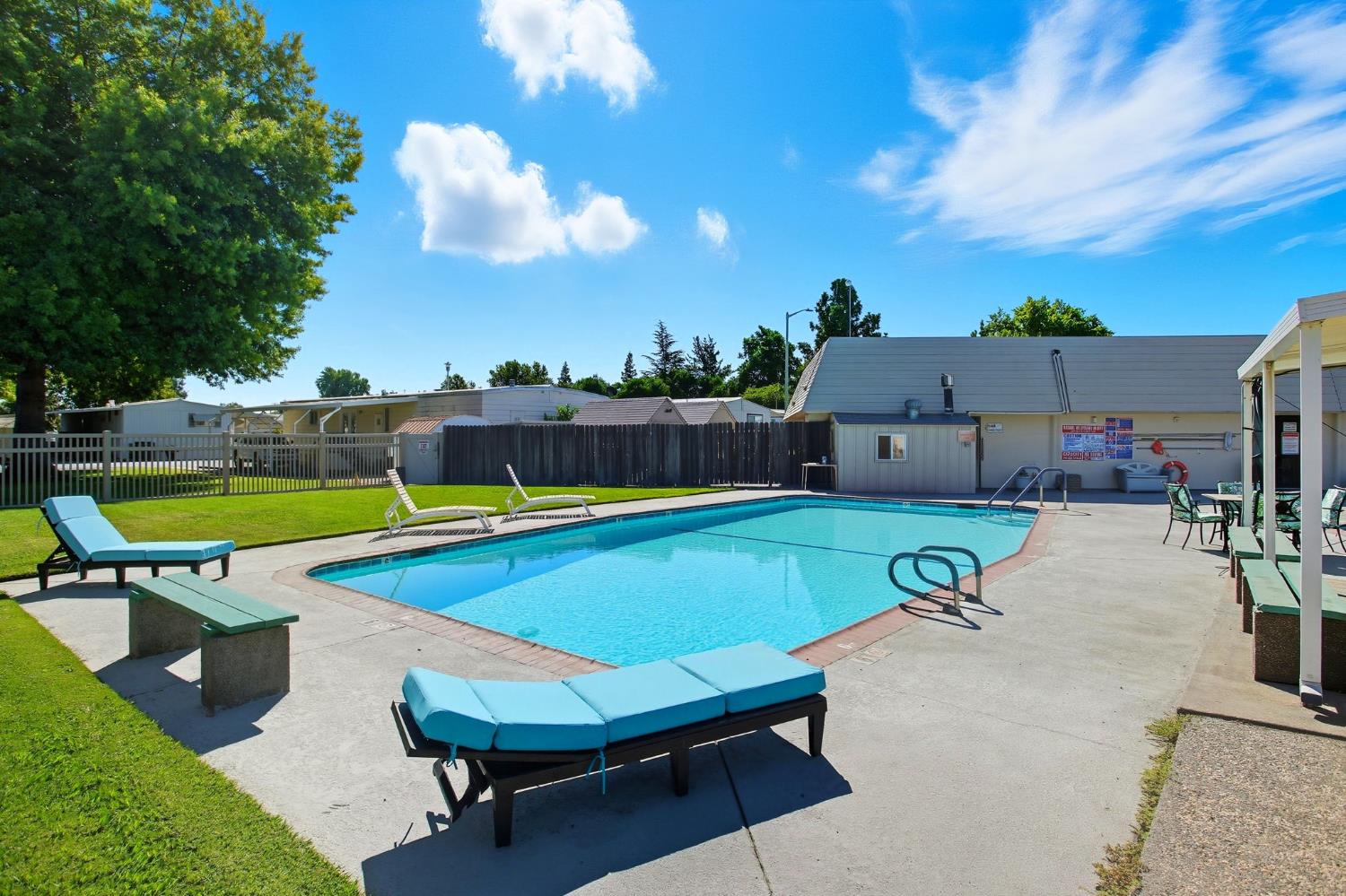 8665 Florin Road, Unit 133 Sacramento, CA 95828 - Photo 38 of 38 a view of a swimming pool with a chair and tables