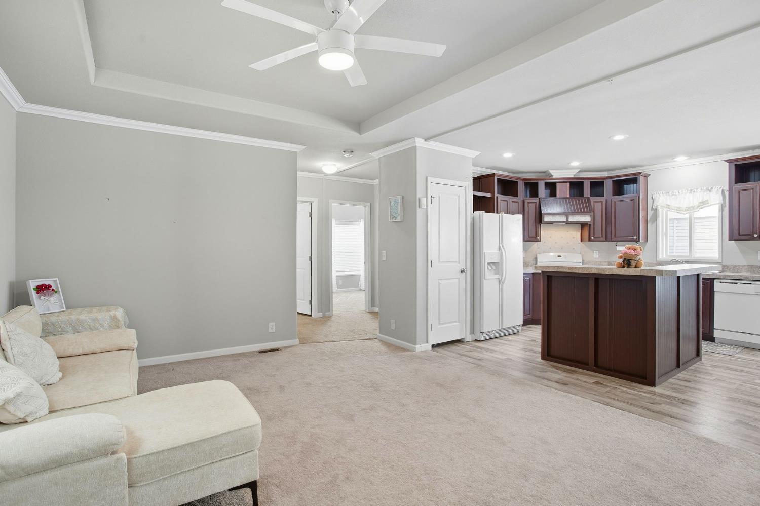 8665 Florin Road, Unit 133 Sacramento, CA 95828 - Photo 4 of 38 a living room with a couch and a view of kitchen
