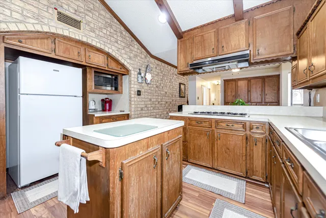 a kitchen with a stove a sink and a refrigerator