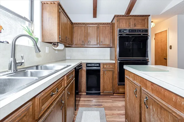 a kitchen with stainless steel appliances granite countertop a sink and a stove