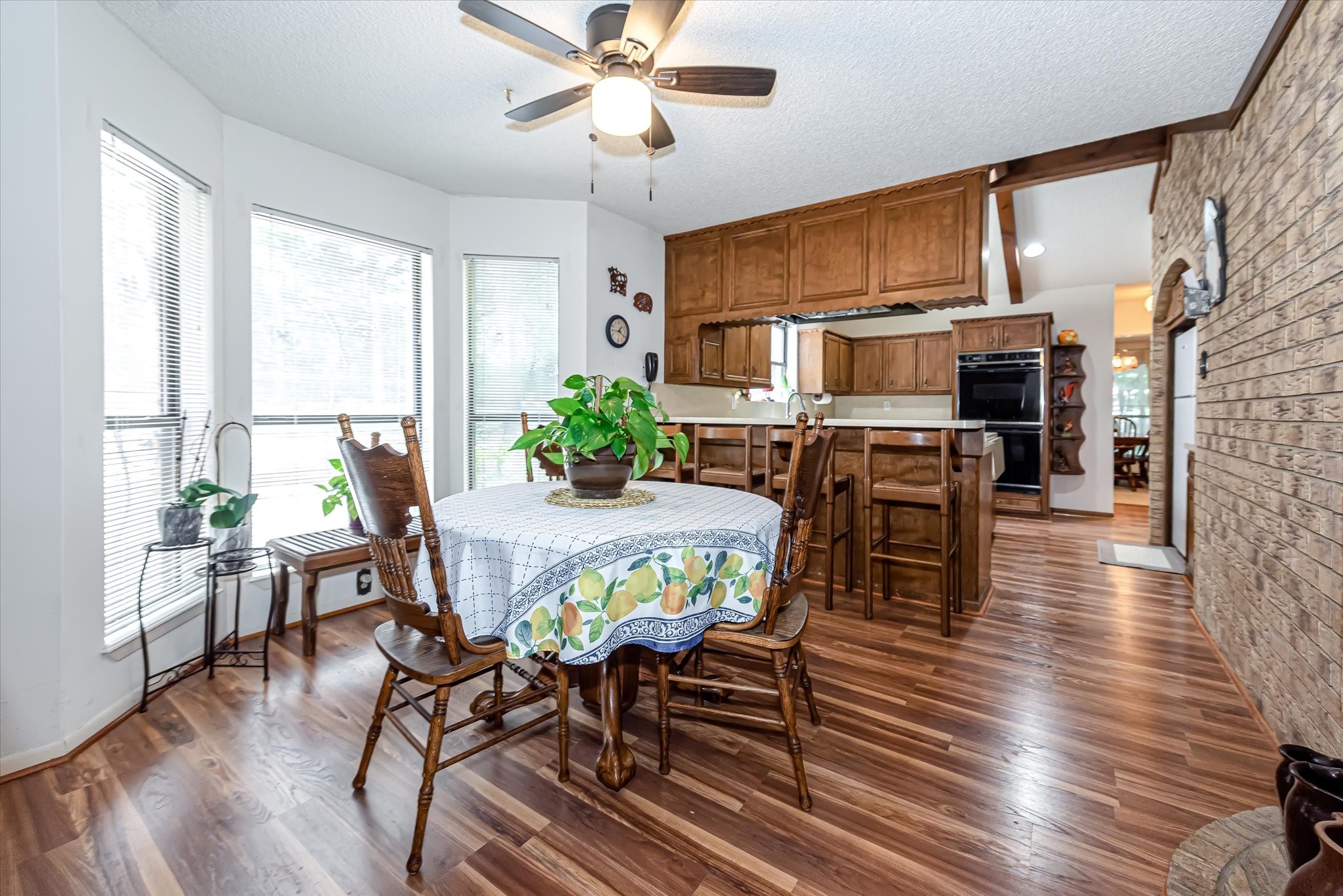 7715 Shadow Lane Conroe, TX 77304 - Photo 16 of 46 a view of a dining room with furniture window and wooden floor