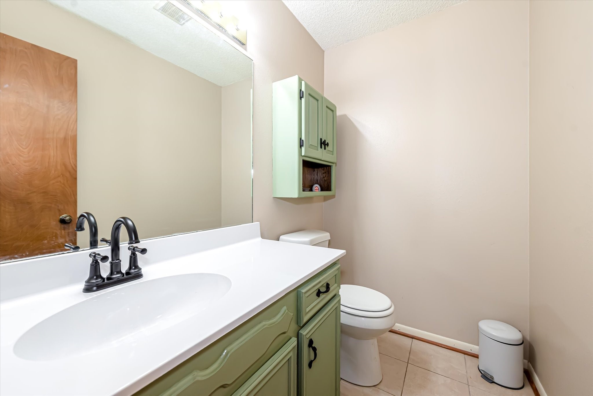 7715 Shadow Lane Conroe, TX 77304 - Photo 20 of 46 a bathroom with a sink a toilet and mirror