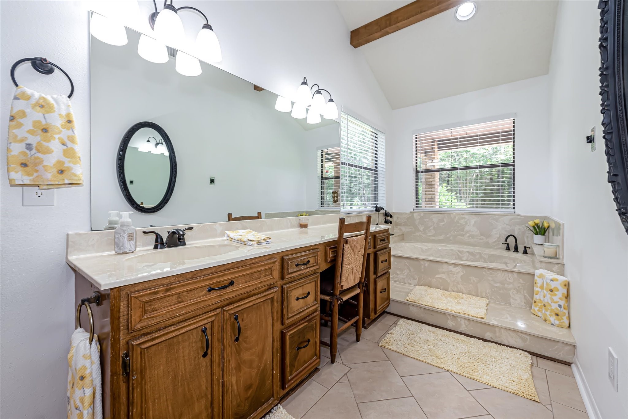 7715 Shadow Lane Conroe, TX 77304 - Photo 27 of 46 a bathroom with a tub sink and mirror