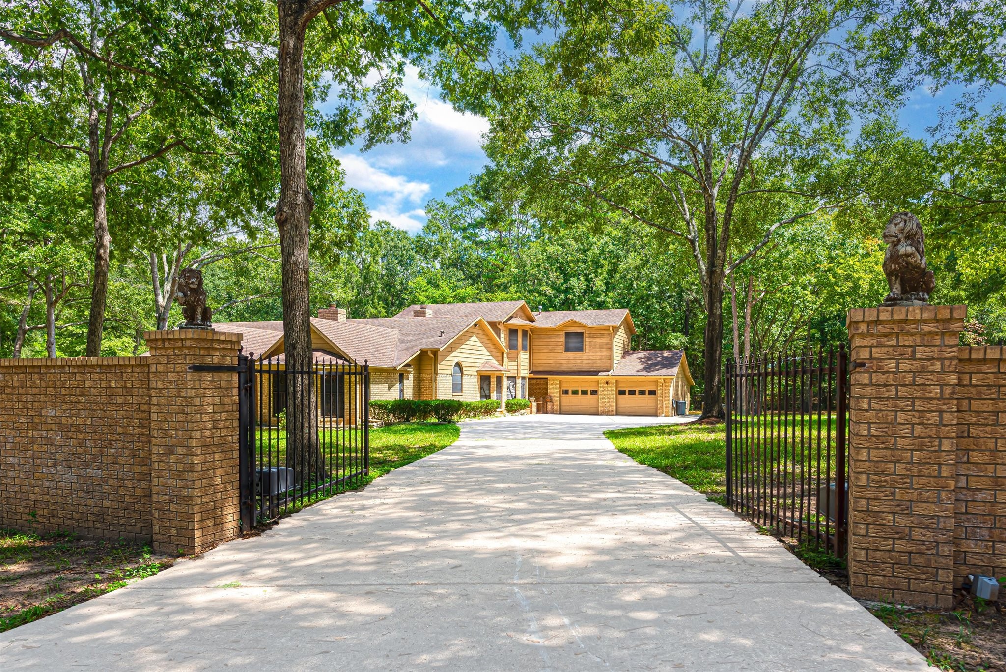 7715 Shadow Lane Conroe, TX 77304 - Photo 3 of 46 a front view of a house with a yard and fountain