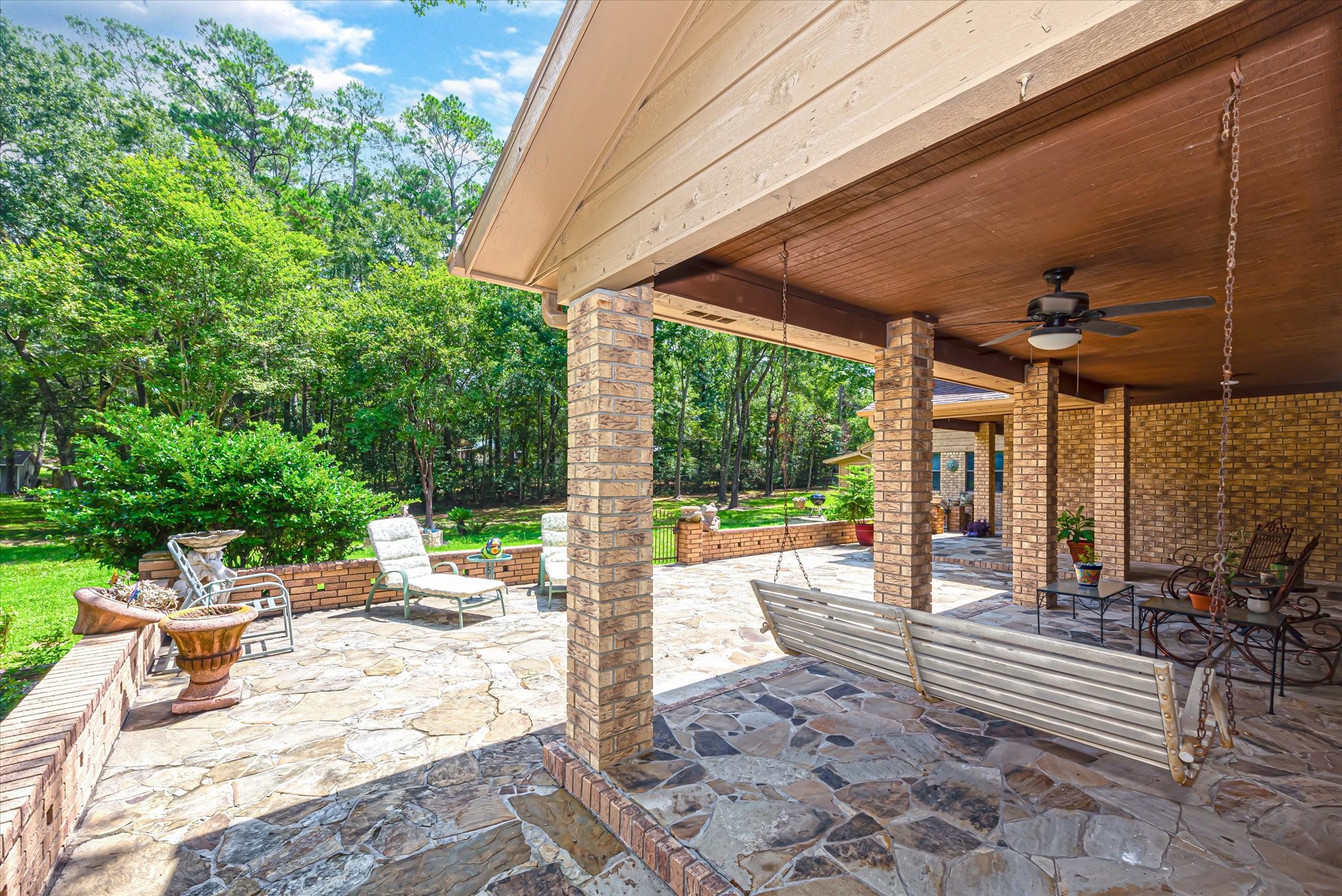 7715 Shadow Lane Conroe, TX 77304 - Photo 35 of 46 a view of a patio with a dining table and chairs with wooden floor and fence