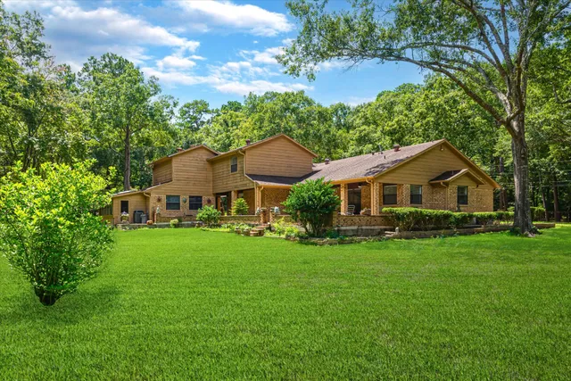 a front view of a house with yard and green space