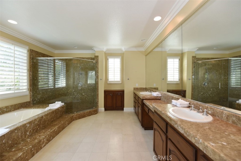 12 Brigadier Irvine, CA 92603 - Photo 39 of 50 a spacious bathroom with a granite countertop sink a toilet a mirror and bathtub