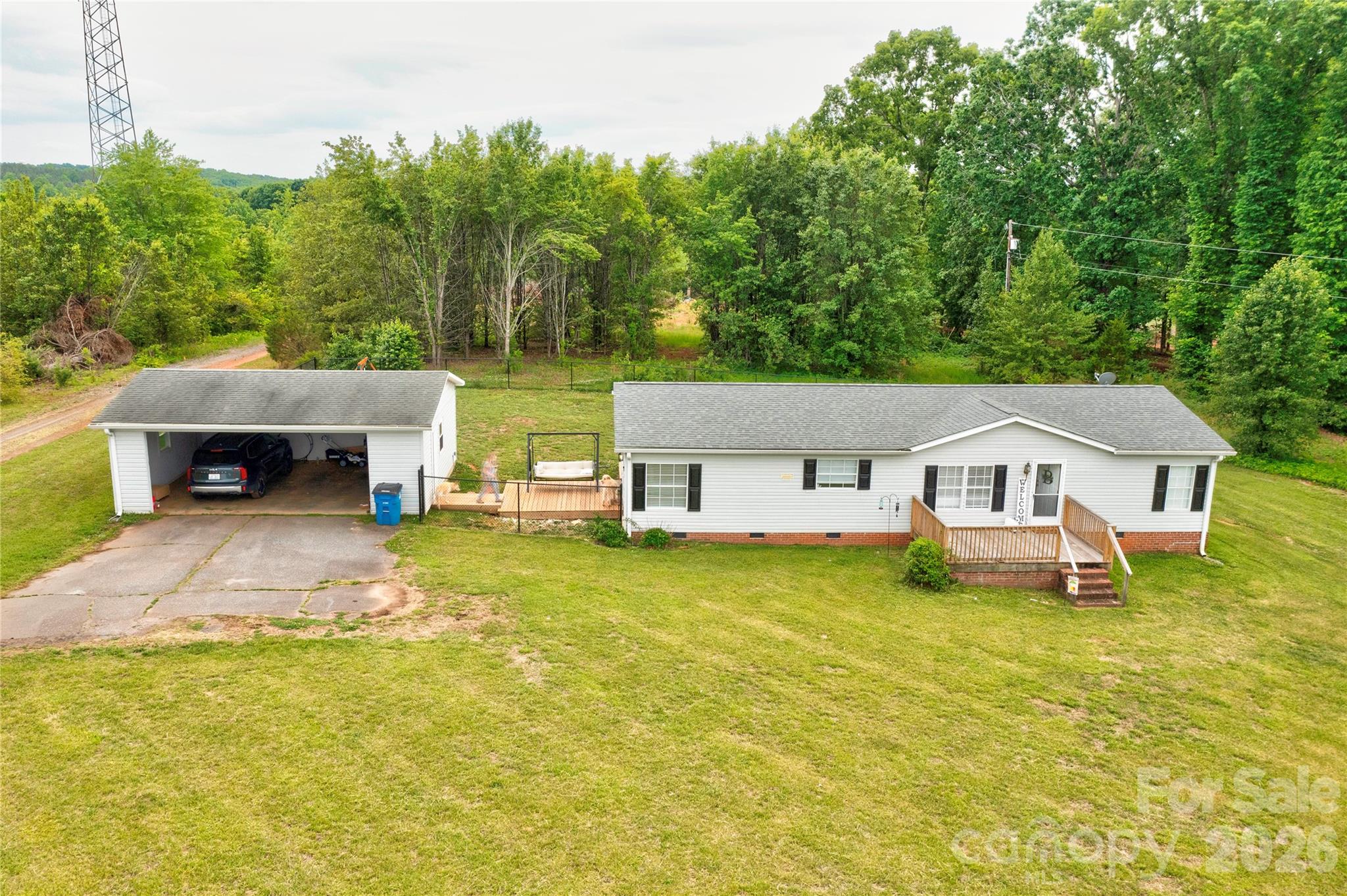 251 Indian Trail Rutherfordton, NC 28139 - Photo 1 of 37 a front view of a house with a garden and trees