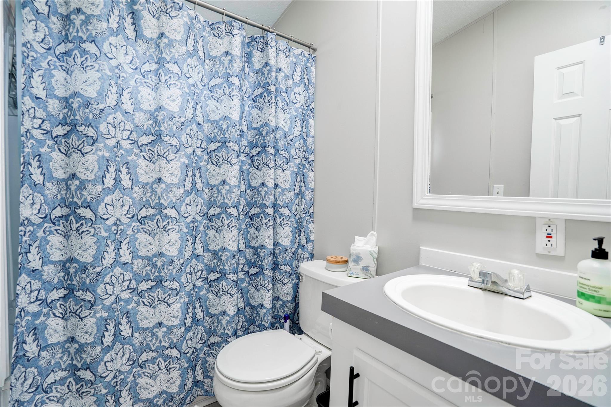 251 Indian Trail Rutherfordton, NC 28139 - Photo 31 of 37 a bathroom with a granite countertop toilet sink and mirror