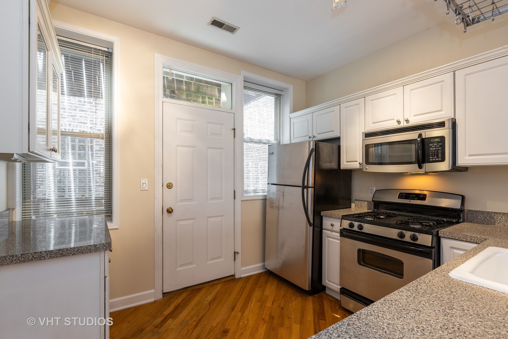 4632 North Racine Avenue, Unit 2 Chicago, IL 60640 - Photo 4 of 12 a kitchen with a refrigerator stove and microwave