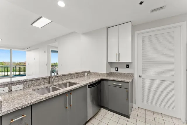 a kitchen with stainless steel appliances white cabinets a stove and a microwave