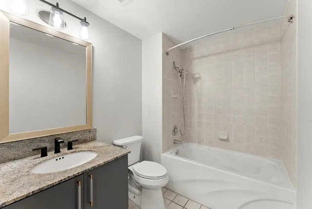 an empty room with windows and ceiling fan