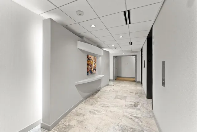 a living room with a gaming machine and a table